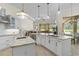 Well-lit kitchen with stainless appliances, white cabinets and marble countertops at 6801 Silver Charm Ct, Leesburg, FL 34748