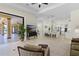 Open concept floor plan connecting the living room with an island, white cabinets, and barstool seating at 6801 Silver Charm Ct, Leesburg, FL 34748