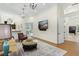 An inviting living room with dark wood floors, modern fixtures, and outdoor views at 6801 Silver Charm Ct, Leesburg, FL 34748