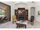 Elegant living room featuring a fireplace, built-in shelving, and access to the outdoor space through sliding glass doors at 6801 Silver Charm Ct, Leesburg, FL 34748