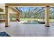 Expansive covered patio with a sparkling pool, spa, and outdoor entertainment area at 6801 Silver Charm Ct, Leesburg, FL 34748