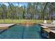 Gorgeous pool with tiled waterfall feature in a screened enclosure, offering a serene backyard retreat at 6801 Silver Charm Ct, Leesburg, FL 34748