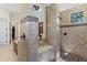 Large walk-in shower with dual shower heads and tile flooring at 6801 Silver Charm Ct, Leesburg, FL 34748