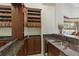 Stylish wet bar featuring granite counters, wine storage, and a sink for effortless entertaining with pool views at 6801 Silver Charm Ct, Leesburg, FL 34748