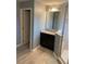 Bathroom featuring a granite vanity, a clear glass shower, and gray tile flooring at 7040 Oxbow Rd, Minneola, FL 34715