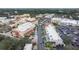 Aerial photograph capturing a charming town square featuring quaint buildings, landscaped areas, and neatly arranged parking spots at 723 Palma Dr, Lady Lake, FL 32159