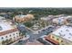 Aerial view capturing a charming town square featuring landscaping, surrounding buildings, and neatly arranged parking at 723 Palma Dr, Lady Lake, FL 32159