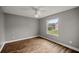 Comfortable bedroom featuring hardwood floors, a ceiling fan, and a bright window at 723 Palma Dr, Lady Lake, FL 32159