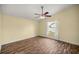 This bedroom features wood-look floors, a ceiling fan, and a window for natural light at 723 Palma Dr, Lady Lake, FL 32159