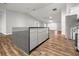 Modern kitchen island with hardwood floors and stainless steel appliances at 723 Palma Dr, Lady Lake, FL 32159