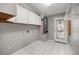 Clean laundry room with storage cabinets and tile flooring at 723 Palma Dr, Lady Lake, FL 32159