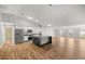 Open-concept living room with modern kitchen island and hardwood floors at 723 Palma Dr, Lady Lake, FL 32159