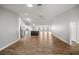 Expansive living room featuring hardwood floors, skylights, and an open layout to the kitchen at 723 Palma Dr, Lady Lake, FL 32159