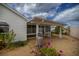 Covered patio with a view of the fenced yard and lush landscaping at 723 Palma Dr, Lady Lake, FL 32159