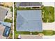 Aerial view of the home showing the roof, screened lanai, and proximity to other homes at 879 Pisano Way, The Villages, FL 32163