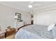 Bedroom featuring a wooden bedframe, ample natural light, and neutral decor at 879 Pisano Way, The Villages, FL 32163