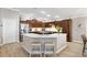 Gourmet kitchen with granite countertops, a large island, and custom cabinetry at 879 Pisano Way, The Villages, FL 32163