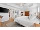 Bright main bedroom features a tray ceiling, wood floors, and an ensuite bathroom at 879 Pisano Way, The Villages, FL 32163