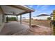 The covered back porch has a fan, a brick paved border, and overlooks the spacious back yard at 902 Chestnut Dr, Fruitland Park, FL 34731