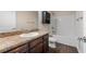 Well-lit bathroom features dark wood cabinets, granite countertop, and a shower over tub at 902 Chestnut Dr, Fruitland Park, FL 34731