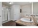 Bathroom featuring double sinks with granite countertops and a walk-in shower at 902 Chestnut Dr, Fruitland Park, FL 34731