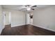 Bedroom with hardwood floors, a ceiling fan, and a doorway leading to the kitchen at 902 Chestnut Dr, Fruitland Park, FL 34731