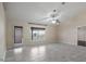 Spacious living room with a large window and access to the patio at 902 Chestnut Dr, Fruitland Park, FL 34731