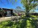 A well-maintained backyard with a screened-in porch and lush green lawn at 1004 Matthew Ave, Lady Lake, FL 32159