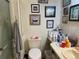 Cozy bathroom with a sink, toilet, shower, and wall decor at 1004 Matthew Ave, Lady Lake, FL 32159