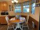 Cozy dining area with charming chandelier and corner windows at 1004 Matthew Ave, Lady Lake, FL 32159