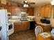 Functional kitchen with wood cabinets, tile countertops, and white appliances at 1004 Matthew Ave, Lady Lake, FL 32159