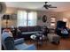 Well-lit living room offering wood floors, a ceiling fan, and casual seating arrangement at 1004 Matthew Ave, Lady Lake, FL 32159