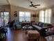Inviting living room featuring wood floors, ceiling fan, and comfortable seating at 1004 Matthew Ave, Lady Lake, FL 32159