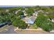 Aerial view of a charming home nestled among lush greenery in a quiet neighborhood at 1013 Lake Elsie Dr, Tavares, FL 32778