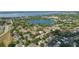 Stunning aerial view showcasing a lake, surrounding homes, and neighborhood at 1013 Lake Elsie Dr, Tavares, FL 32778