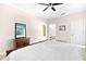 Cozy primary bedroom with a wood sleigh bed, classic rug, and an adjoining bathroom at 1013 Lake Elsie Dr, Tavares, FL 32778