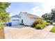 Charming home with a two-car garage, well-maintained landscaping, and a spacious driveway at 1013 Lake Elsie Dr, Tavares, FL 32778