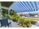 Relaxing front porch with comfortable seating, a blue awning, and a lovely view at 1013 Lake Elsie Dr, Tavares, FL 32778