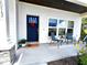 Inviting front porch with comfortable seating, a stylish door, and charming decor at 1013 Lake Elsie Dr, Tavares, FL 32778