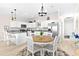 Bright kitchen featuring white cabinets, granite counters, stainless appliances, and a breakfast nook with natural light at 1013 Lake Elsie Dr, Tavares, FL 32778