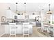 Modern kitchen features white cabinets, granite counters, stainless steel appliances, and a cozy dining space at 1013 Lake Elsie Dr, Tavares, FL 32778