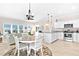 Open concept kitchen with granite countertops, stainless appliances, and an adjacent living and dining area at 1013 Lake Elsie Dr, Tavares, FL 32778