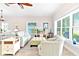 Comfortable living room with cozy seating, bright windows, and stylish decor at 1013 Lake Elsie Dr, Tavares, FL 32778