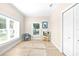 Inviting living room with natural light, wood floors, and a closet for extra storage at 1013 Lake Elsie Dr, Tavares, FL 32778