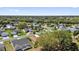 An aerial view showcases homes within a verdant neighborhood of tree-lined streets and manicured lawns at 1029 Soledad Way, The Villages, FL 32159