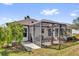 Exterior view of a home featuring a screened lanai, patio area and views of the backyard at 1029 Soledad Way, The Villages, FL 32159