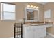 Bathroom vanity with granite countertops and an enclosed glass shower at 1029 Soledad Way, The Villages, FL 32159