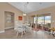 Cozy dining area with a white table set and sliding glass doors leading to a screened lanai at 1029 Soledad Way, The Villages, FL 32159