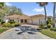 Charming single-story home with a well-manicured lawn, stone driveway, and an attached two-car garage at 1029 Soledad Way, The Villages, FL 32159