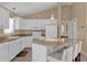 Modern kitchen featuring white cabinets, stainless steel appliances, and a breakfast bar at 1029 Soledad Way, The Villages, FL 32159